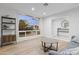 Bright living room featuring hardwood floors, a large window with backyard views, and modern decor at 3429 E Coolidge St, Phoenix, AZ 85018