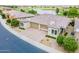 Aerial view of a home with a well-manicured lawn, tile roof, and a beautiful golf course backdrop at 36047 N Copper Hollow Way, Queen Creek, AZ 85140