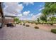 Expansive backyard with covered patio, desert landscaping, and golf course views at 36047 N Copper Hollow Way, Queen Creek, AZ 85140