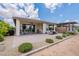 Backyard with covered patio, lush landscaping, and tranquil golf course views at 36047 N Copper Hollow Way, Queen Creek, AZ 85140
