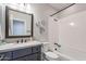 Bathroom featuring a combination tub and shower, updated vanity, framed mirror, and modern lighting fixtures at 36047 N Copper Hollow Way, Queen Creek, AZ 85140