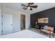 Cozy bedroom featuring a dark accent wall, natural lighting, and an ensuite bathroom at 36047 N Copper Hollow Way, Queen Creek, AZ 85140