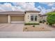 Charming single-story home with a well-manicured front yard and a two-car garage at 36047 N Copper Hollow Way, Queen Creek, AZ 85140