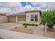 Charming single-story home with a well-manicured front yard and a two-car garage at 36047 N Copper Hollow Way, Queen Creek, AZ 85140