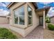 Inviting home exterior featuring brick pathway, desert landscaping, and large window at 36047 N Copper Hollow Way, Queen Creek, AZ 85140