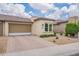 Charming single-story home with a well-manicured front yard and a two-car garage at 36047 N Copper Hollow Way, Queen Creek, AZ 85140
