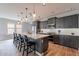 Spacious kitchen with a large island, modern lighting, stainless steel appliances, and wood-style flooring at 36047 N Copper Hollow Way, Queen Creek, AZ 85140