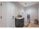 Laundry room with modern appliances, ample counter space, and a door leading to the garage at 36047 N Copper Hollow Way, Queen Creek, AZ 85140