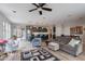 Open-concept living room showcases modern decor and seamless flow to kitchen at 36047 N Copper Hollow Way, Queen Creek, AZ 85140