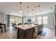 Open concept living and dining space with bright natural light, stainless appliances and access to outdoor patio at 36047 N Copper Hollow Way, Queen Creek, AZ 85140