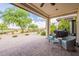 Inviting covered patio with views of the lush green golf course at 36047 N Copper Hollow Way, Queen Creek, AZ 85140