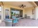 Relaxing covered patio with comfortable seating and ceiling fan at 36047 N Copper Hollow Way, Queen Creek, AZ 85140