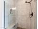 Walk-in shower featuring tile walls, a glass enclosure, and a built-in shower bench at 36047 N Copper Hollow Way, Queen Creek, AZ 85140