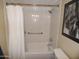 Bathroom with shower and tub combination with white shower curtain and walls at 3726 W Campo Bello Dr, Glendale, AZ 85308