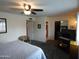 Spacious bedroom featuring a ceiling fan, closet, and doorway to the bathroom at 3726 W Campo Bello Dr, Glendale, AZ 85308