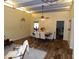 Spacious dining area with wood floors transitioning into carpet in the living room, and a ceiling fan at 3726 W Campo Bello Dr, Glendale, AZ 85308