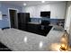 Beautifully renovated kitchen with white and blue cabinets, granite countertops, and sleek appliances at 3726 W Campo Bello Dr, Glendale, AZ 85308