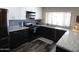 Updated kitchen with white shaker cabinets, black lower cabinets, and modern appliances at 3726 W Campo Bello Dr, Glendale, AZ 85308