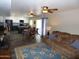 Open-concept living space with a kitchen view, dining table, hardwood floors, and comfortable furnishings at 3726 W Campo Bello Dr, Glendale, AZ 85308