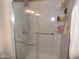 Updated shower with glass doors, grab bars, and tiled walls at 3726 W Campo Bello Dr, Glendale, AZ 85308