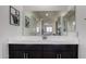 Elegant bathroom featuring a large mirror, framed botanical art, and vanity at 41825 W Mesquite Rd, Maricopa, AZ 85138