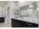 Elegant bathroom with a large mirror, dual sinks, and dark cabinetry at 41825 W Mesquite Rd, Maricopa, AZ 85138