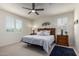 Bedroom features a ceiling fan, two windows, and a cozy ambiance at 41825 W Mesquite Rd, Maricopa, AZ 85138