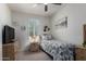 Cozy bedroom features a twin bed, shuttered window, and vintage furnishings at 41825 W Mesquite Rd, Maricopa, AZ 85138