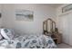 This bedroom features a vintage dresser, an upholstered headboard, and neutral colored walls at 41825 W Mesquite Rd, Maricopa, AZ 85138