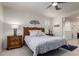 Bedroom features a ceiling fan, two windows, and a cozy ambiance at 41825 W Mesquite Rd, Maricopa, AZ 85138