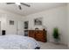 This bedroom features a ceiling fan, a wooden dresser, and carpet flooring at 41825 W Mesquite Rd, Maricopa, AZ 85138