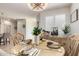 Charming dining room with decorative chandelier, round table and natural light from window at 41825 W Mesquite Rd, Maricopa, AZ 85138
