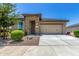 Charming single-story home featuring a stone-accented entrance and a two-car garage at 41825 W Mesquite Rd, Maricopa, AZ 85138