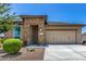 Beautiful single-story home featuring a stone-accented entrance and a two-car garage at 41825 W Mesquite Rd, Maricopa, AZ 85138