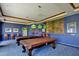 Recreation room featuring pool tables, stylish lighting, and a vibrant atmosphere at 41825 W Mesquite Rd, Maricopa, AZ 85138