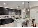 Modern kitchen with granite countertops, stainless steel appliances, and stylish pendant lighting at 41825 W Mesquite Rd, Maricopa, AZ 85138
