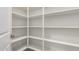 Walk-in pantry with white shelving offers ample storage space for food and supplies at 41825 W Mesquite Rd, Maricopa, AZ 85138