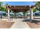 Picturesque outdoor pavilion with comfortable picnic tables overlooking tennis courts at 41825 W Mesquite Rd, Maricopa, AZ 85138