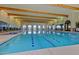 Indoor swimming pool featuring bright lighting and a clear blue pool ready for enjoyment at 41825 W Mesquite Rd, Maricopa, AZ 85138