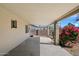 A covered patio area with concrete flooring and a view of the backyard landscaping and block wall at 4257 E Marino Dr, Phoenix, AZ 85032