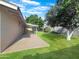 Backyard with a covered patio area, lush lawn, and mature trees providing shade at 4533 W Cavalier Dr, Glendale, AZ 85301