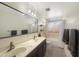 Bright bathroom features a double sink vanity, tub, and grey accent towels at 4533 W Cavalier Dr, Glendale, AZ 85301