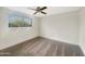 Well lit bedroom featuring a ceiling fan, window and plush carpet at 4533 W Cavalier Dr, Glendale, AZ 85301
