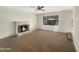 Spacious living room features a classic brick fireplace and a ceiling fan at 4533 W Cavalier Dr, Glendale, AZ 85301