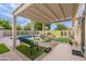 Inviting backyard with a covered patio, sparkling pool, and well-manicured landscaping at 490 W Encinas St, Gilbert, AZ 85233
