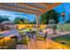 Backyard patio and pool with outdoor seating and lush landscaping, ideal for entertaining at 490 W Encinas St, Gilbert, AZ 85233