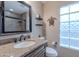 Bathroom with granite countertop, modern faucet, and glass block window for natural light at 490 W Encinas St, Gilbert, AZ 85233