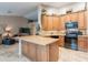 Spacious kitchen with stainless steel appliances, a center island, and decorative accents at 490 W Encinas St, Gilbert, AZ 85233