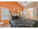 Cozy main bedroom featuring a decorative headboard and a view into the main bathroom at 490 W Encinas St, Gilbert, AZ 85233