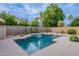 Private pool featuring a modern waterfall feature, tiled accents, and lush landscaping at 490 W Encinas St, Gilbert, AZ 85233